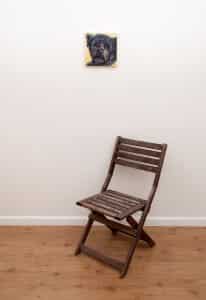Pet portrait of a french bulldog by artist Erica Eriksdotter and a chair