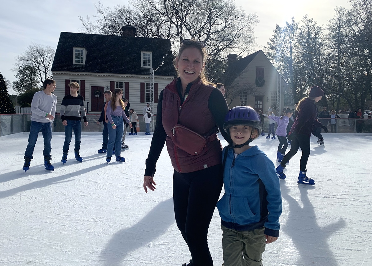 Parent and child ice skating at Colonial Williamsburg for DIY advent calendar experience.