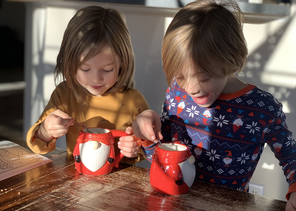 Kids enjoying hot chocolate as part of cozy DIY advent calendar activities.